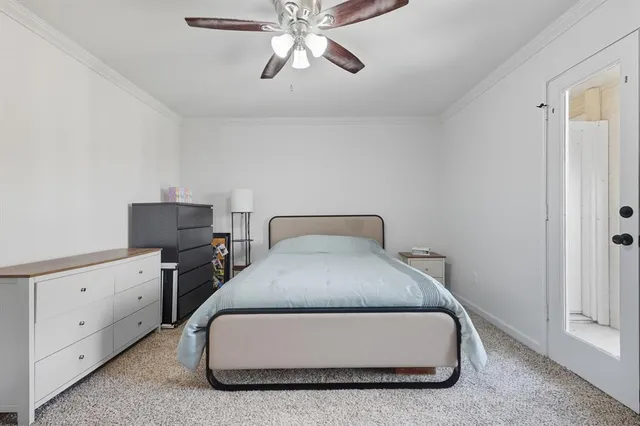 a room with a bed and a ceiling fan