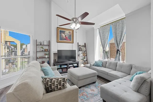a living room with furniture a large window and a flat screen tv