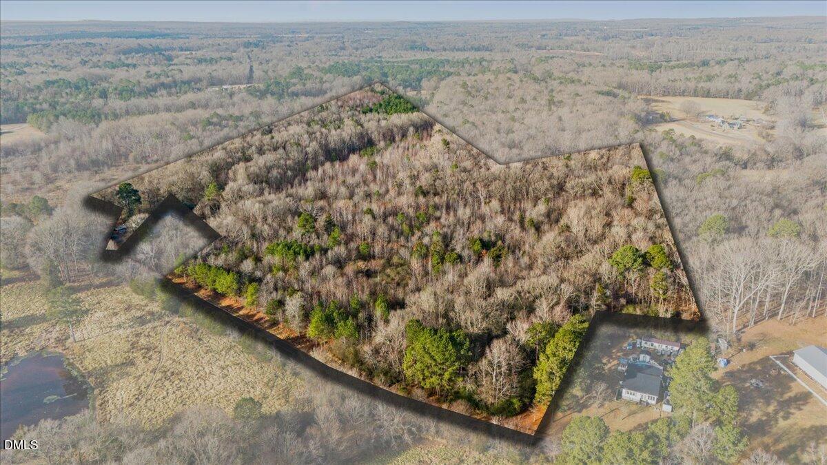 a view of a yard with wooden fence