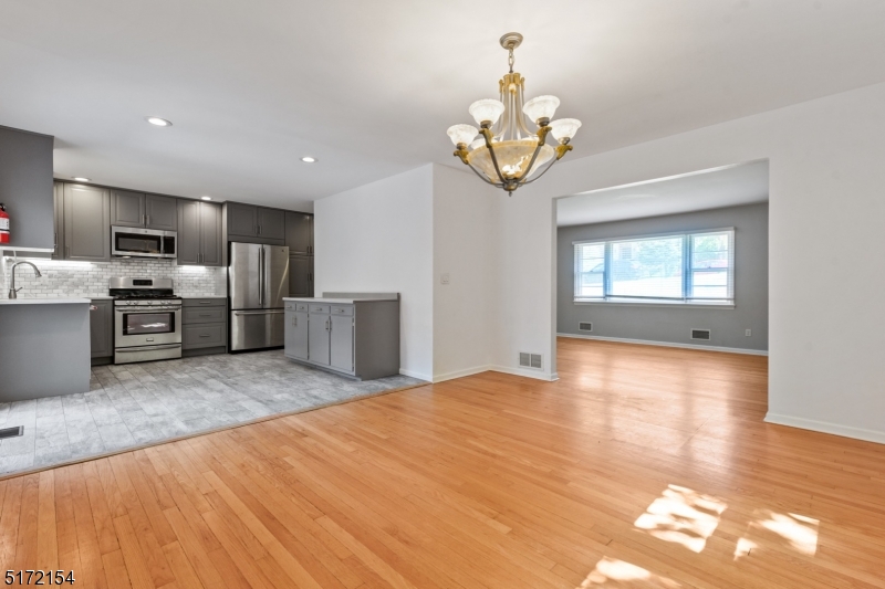 a view of a kitchen with a sink and a refrigerator