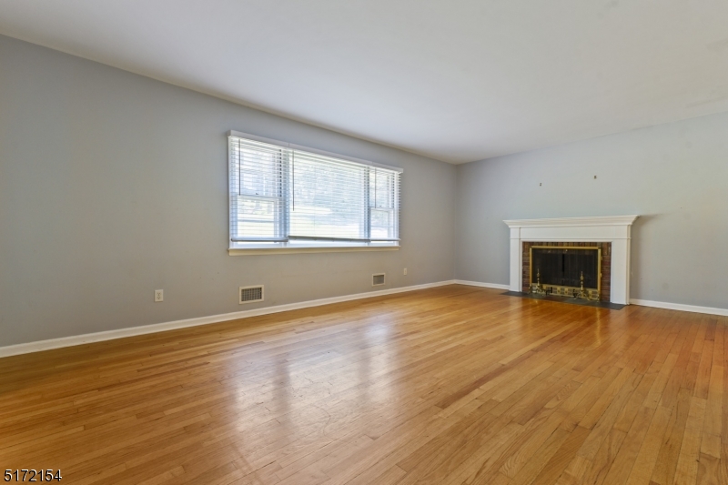 41 Prospect Road Livingston, NJ 07039 - Photo 3 of 14 an empty room with wooden floor and a window