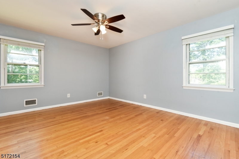 41 Prospect Road Livingston, NJ 07039 - Photo 5 of 14 a view of an empty room with a window and wooden floor