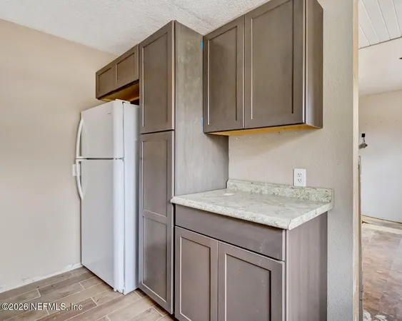 a kitchen with a sink and a refrigerator