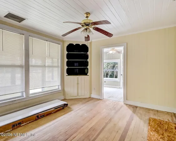 a view of room with window and wooden floor