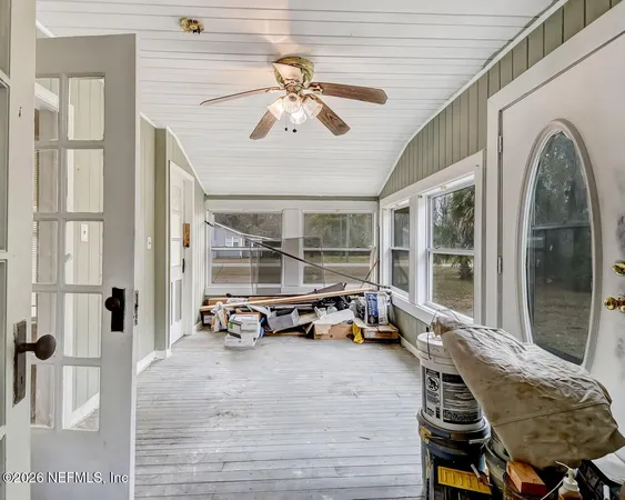 a view of an empty room and wooden floor