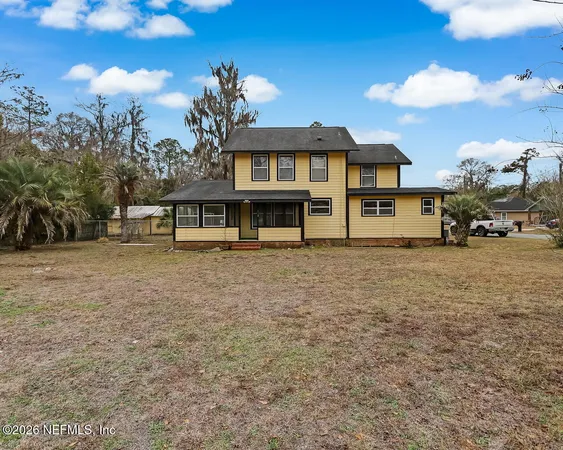 a view of a house with a yard