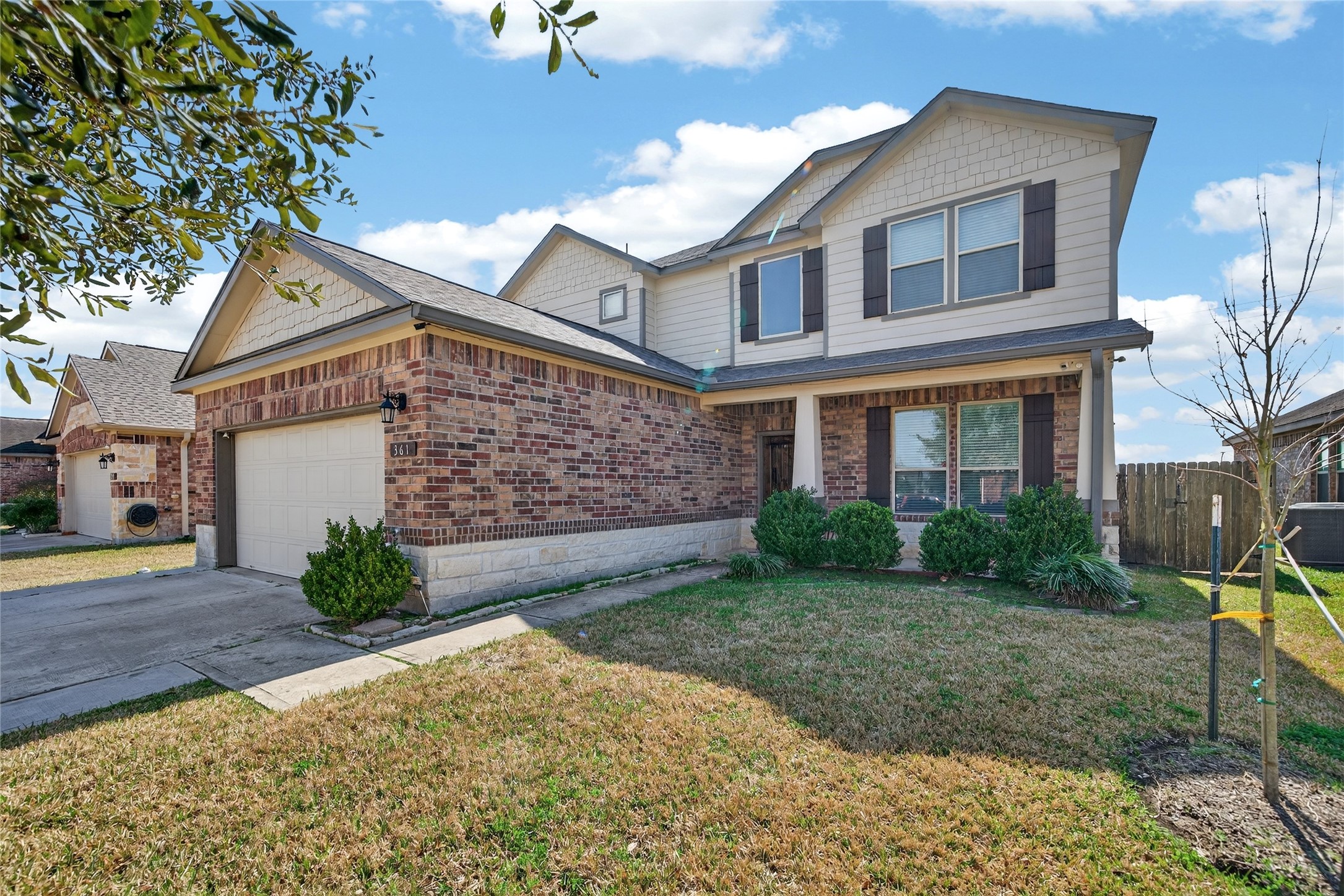 Boasting fantastic curb appeal, this beautiful two-story home features a striking brick and stone elevation complemented by classic shutters and a well-manicured lawn."