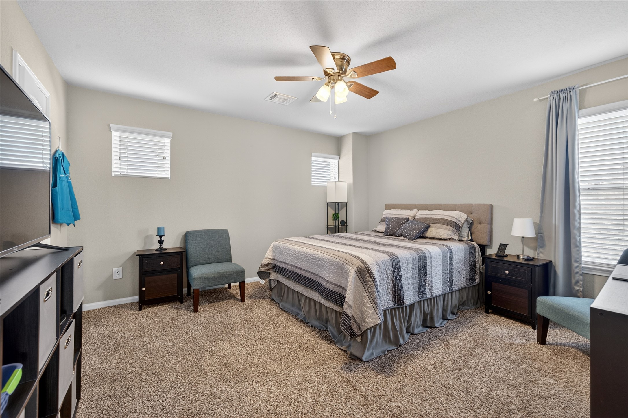 361 Lake Line Drive Alvin, TX 77511 - Photo 21 of 36 Generously sized guest bedroom featuring tall ceilings, a ceiling fan for comfort, and a neutral aesthetic that makes it easy to personalize. The large window provides a serene view of the outdoors.This room has it's own bathroom.