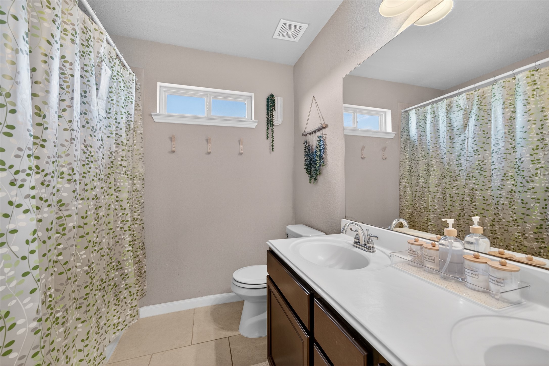 361 Lake Line Drive Alvin, TX 77511 - Photo 22 of 36 A second full bathroom offers a wide vanity with upgraded lighting fixtures. The neutral tones and well-maintained finishes ensure a turn-key experience for your family or guests."