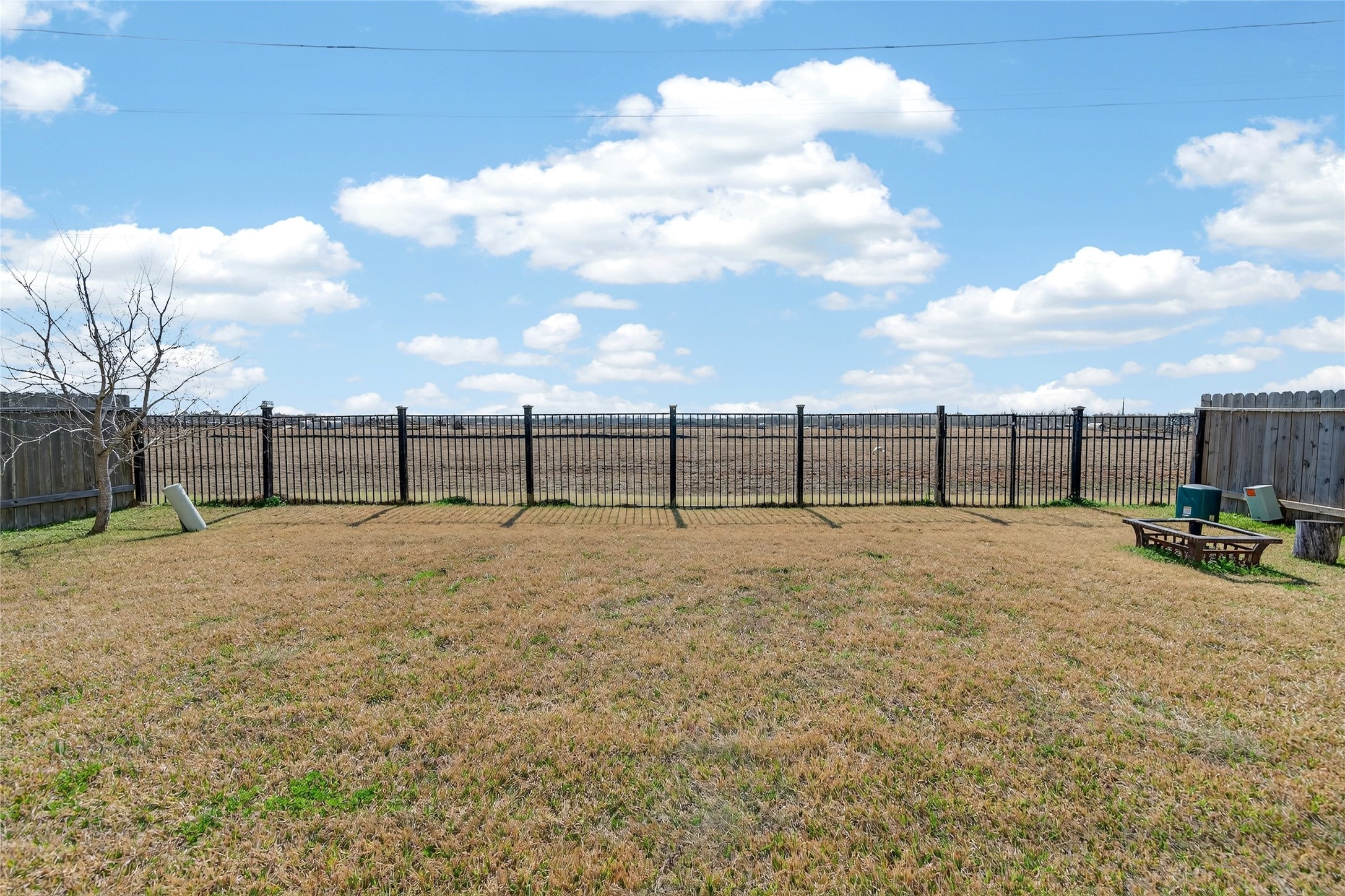 361 Lake Line Drive Alvin, TX 77511 - Photo 24 of 36 Enjoy wide-open views from your backyard, featuring a low-maintenance wrought-iron fence along the rear to preserve the sense of space and sky