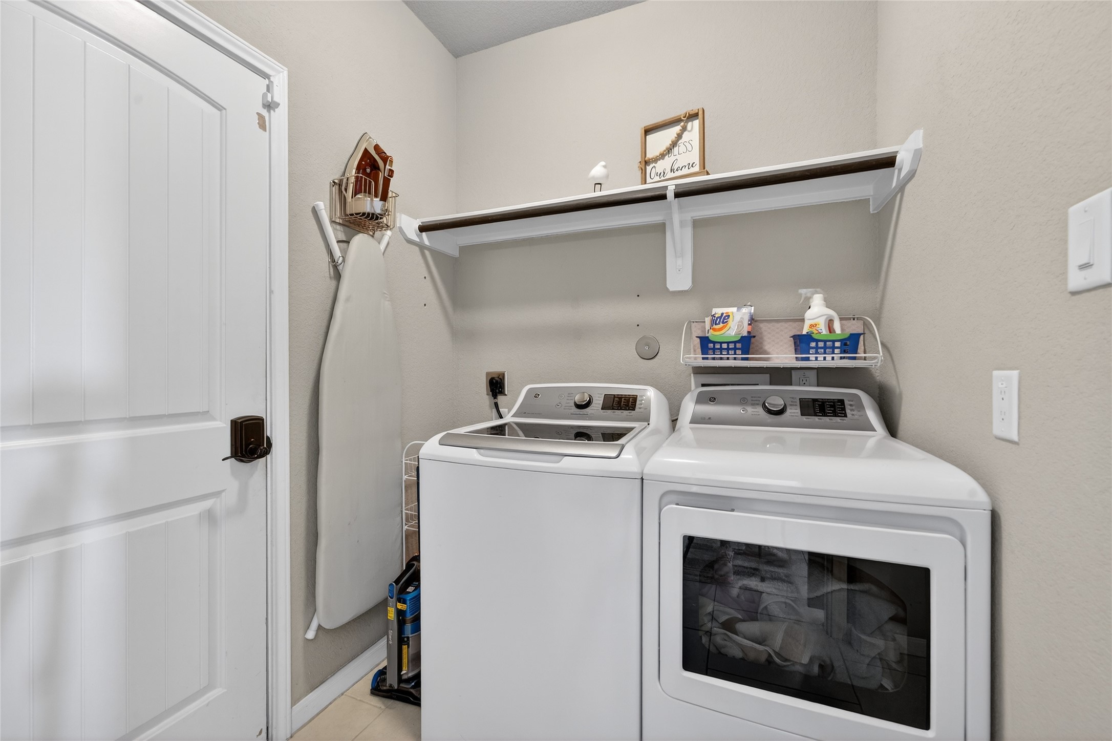361 Lake Line Drive Alvin, TX 77511 - Photo 25 of 36 he functional laundry room is conveniently located on the main level, offering built-in shelving and plenty of room for high-efficiency appliances.
