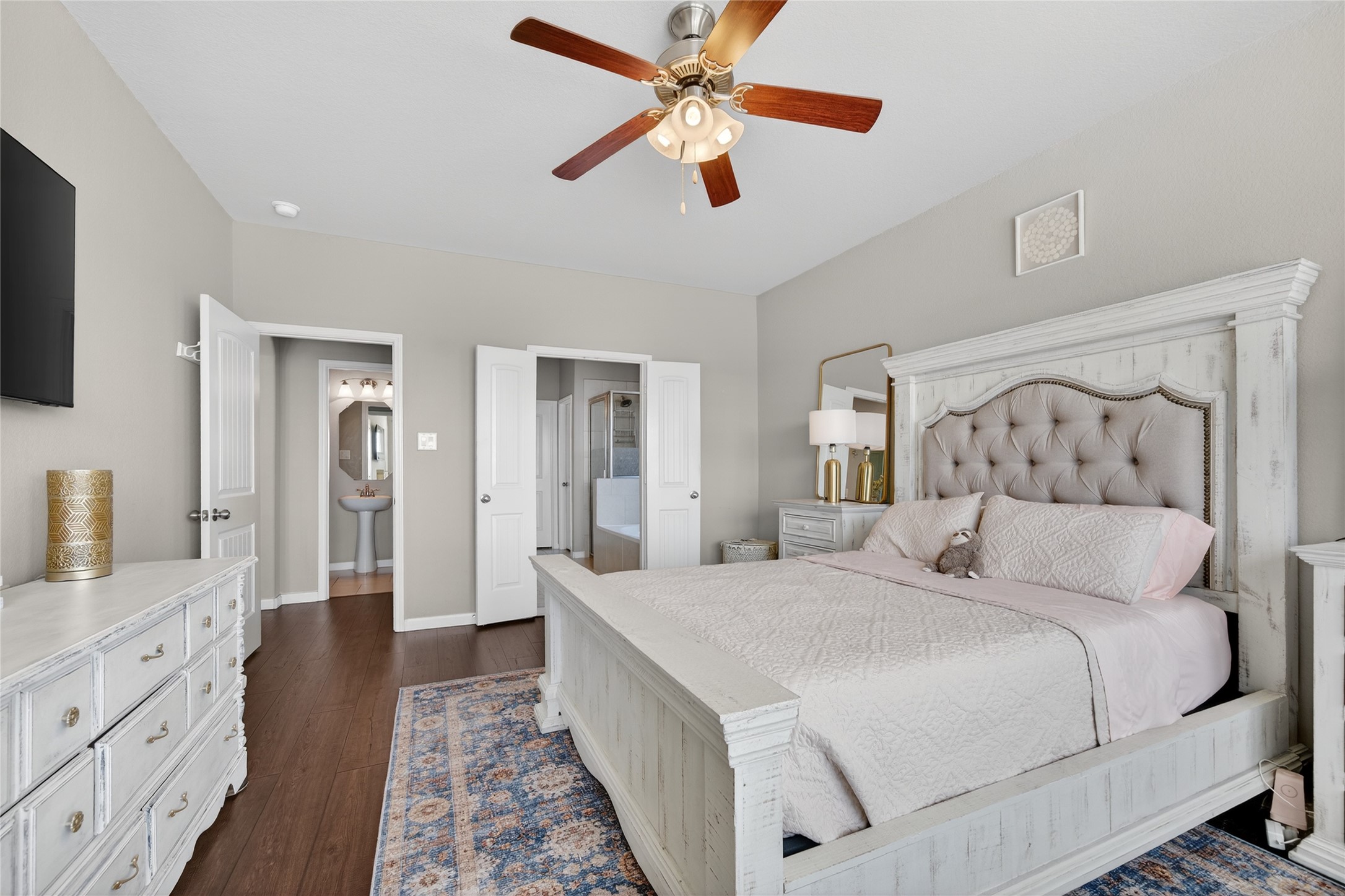 361 Lake Line Drive Alvin, TX 77511 - Photo 9 of 36 The expansive primary suite is a true retreat, featuring a neutral color palette and ample space for a king-sized bedroom set.