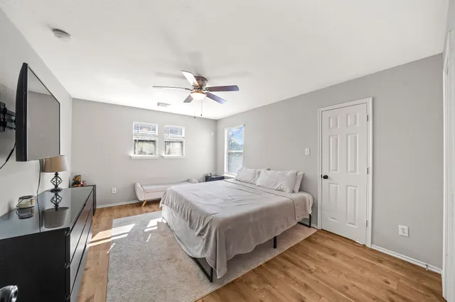 a bedroom with a bed and a chandelier