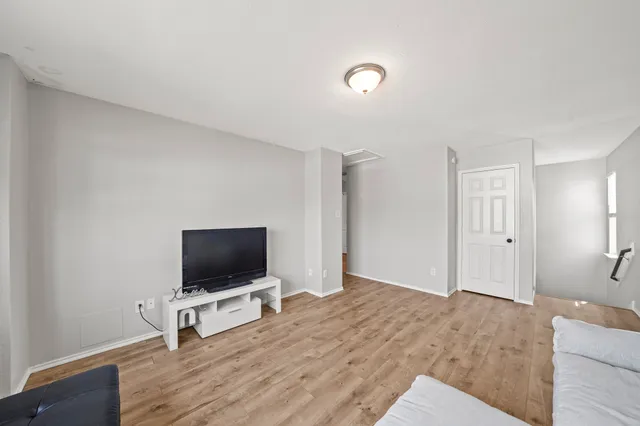 a living room with a flat screen tv and a couch