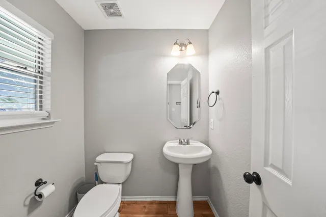 a bathroom with a sink toilet and a mirror