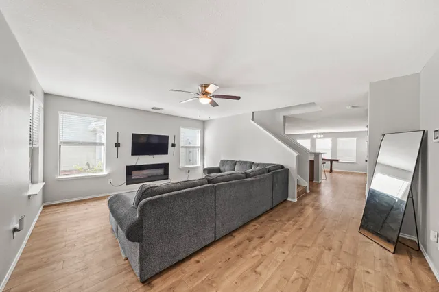 a living room with furniture and a flat screen tv