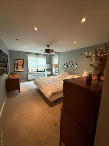 a bedroom with a bed and window