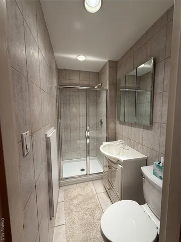 a bathroom with a toilet a sink and shower
