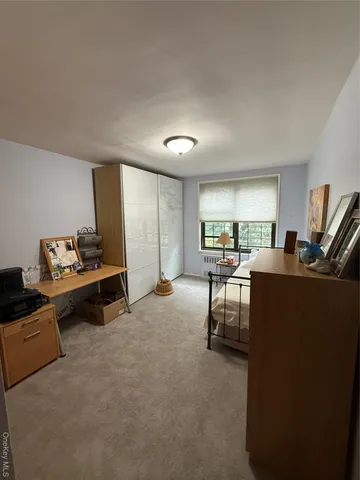 a view of a livingroom with workspace and a window