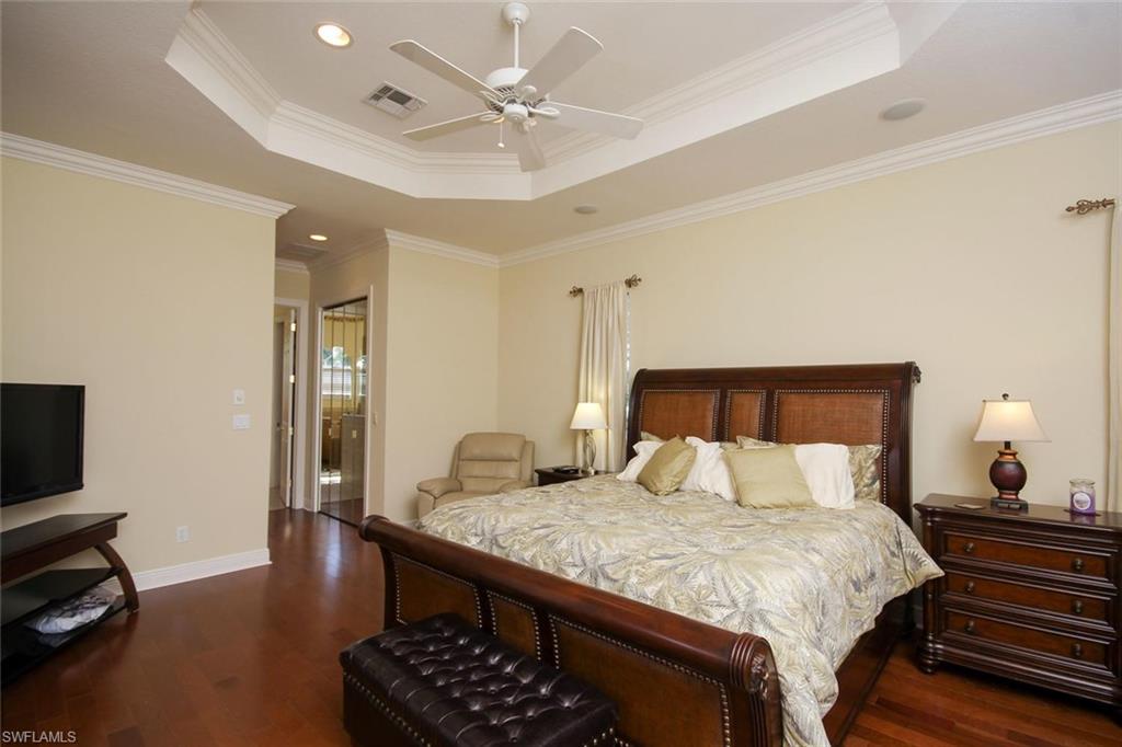 24978 Paradise Road Bonita Springs, FL 34135 - Photo 11 of 25 a bedroom with a bed and a chandelier