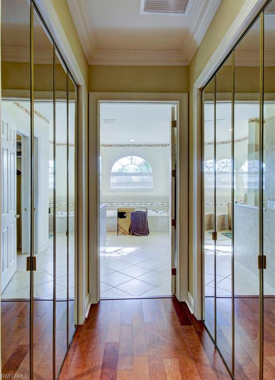 24978 Paradise Road Bonita Springs, FL 34135 - Photo 12 of 25 a view of a hallway view with wooden floor and staircase
