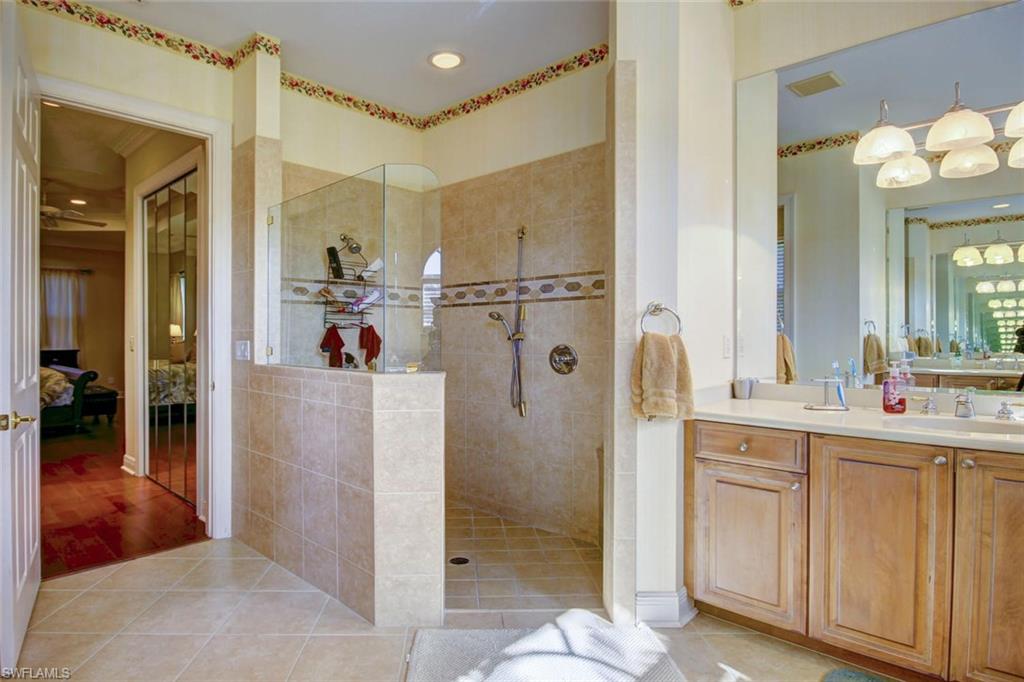 24978 Paradise Road Bonita Springs, FL 34135 - Photo 16 of 25 a bathroom with a sink and a mirror