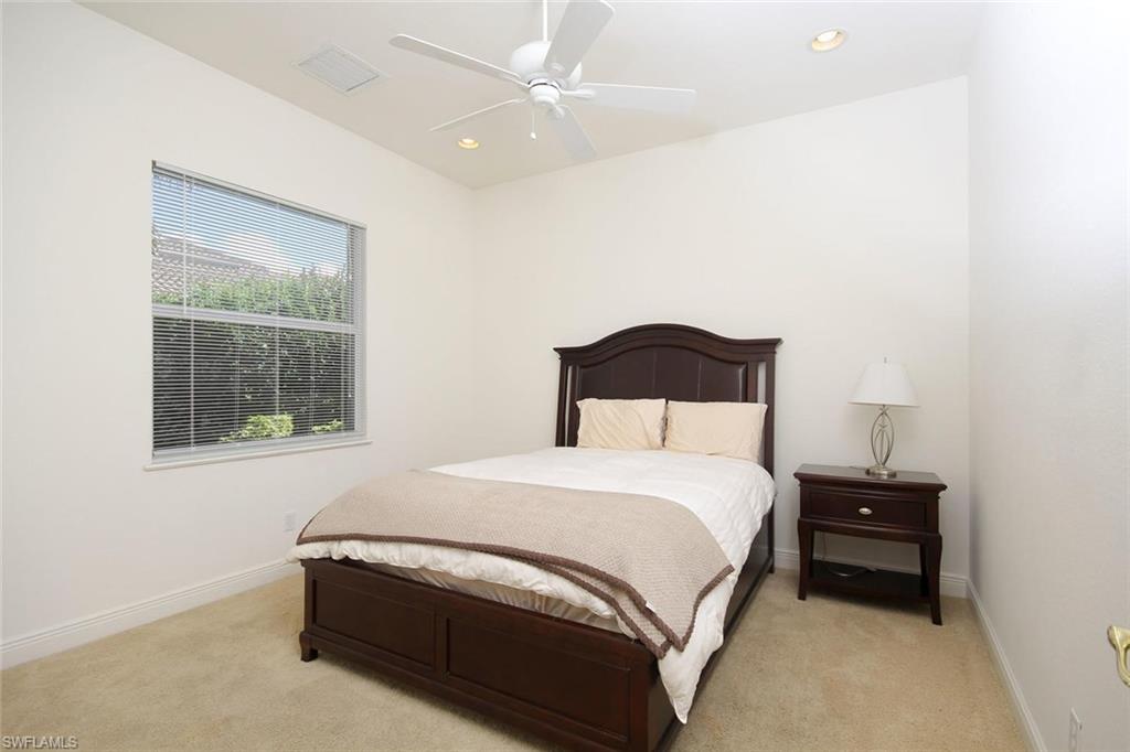 24978 Paradise Road Bonita Springs, FL 34135 - Photo 17 of 25 a bedroom with a bed and a window