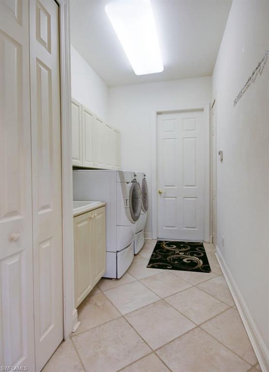 24978 Paradise Road Bonita Springs, FL 34135 - Photo 19 of 25 a utility room with cabinets and washer