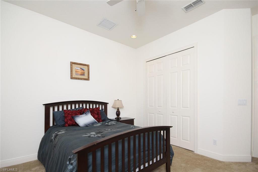 24978 Paradise Road Bonita Springs, FL 34135 - Photo 20 of 25 a bedroom with a bed and a table