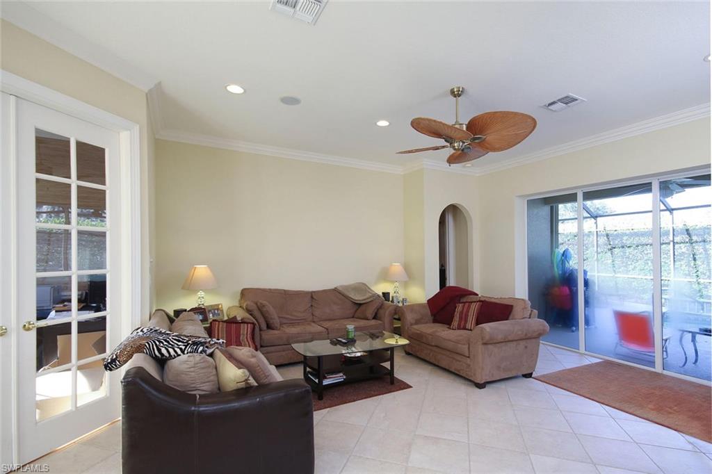 24978 Paradise Road Bonita Springs, FL 34135 - Photo 2 of 25 a living room with furniture and a large window