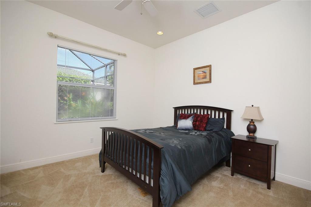 24978 Paradise Road Bonita Springs, FL 34135 - Photo 21 of 25 a bedroom with a bed and a window