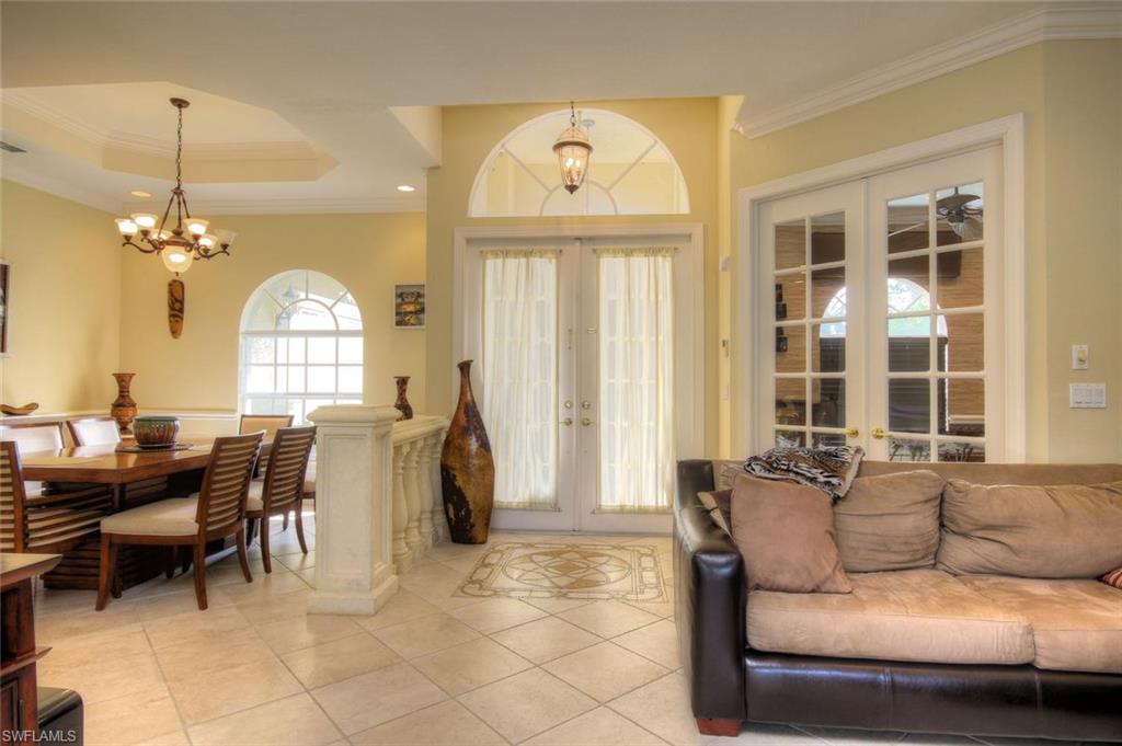 24978 Paradise Road Bonita Springs, FL 34135 - Photo 23 of 25 a living room with furniture a dining table and a large window