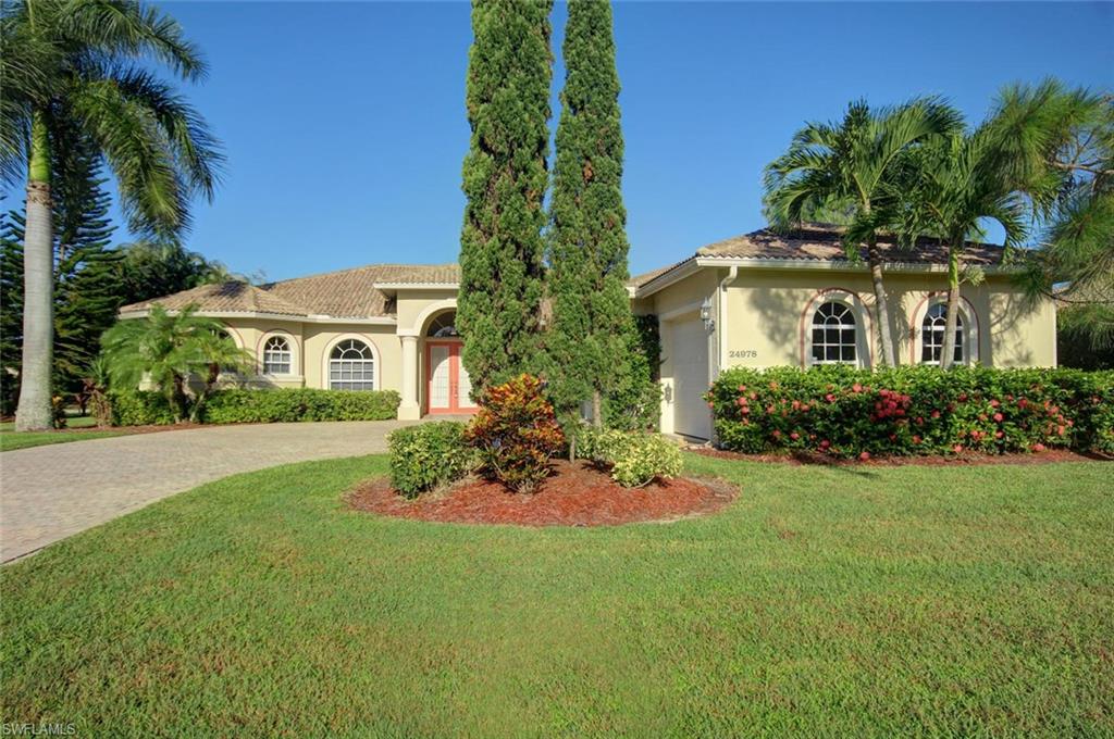 24978 Paradise Road Bonita Springs, FL 34135 - Photo 25 of 25 a front view of a house with a garden