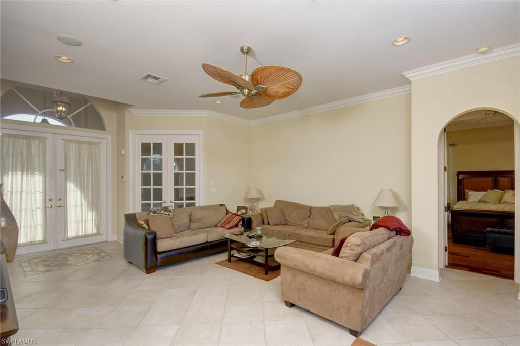 24978 Paradise Road Bonita Springs, FL 34135 - Photo 3 of 25 a living room with furniture ceiling fan and a rug