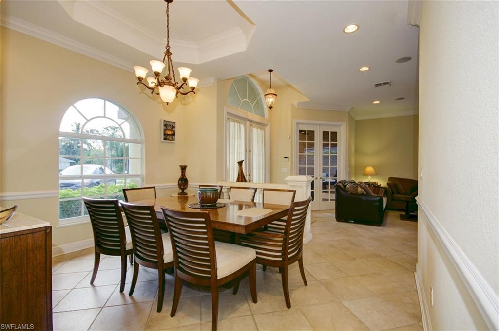 24978 Paradise Road Bonita Springs, FL 34135 - Photo 5 of 25 a view of a dining room with furniture a chandelier and a window