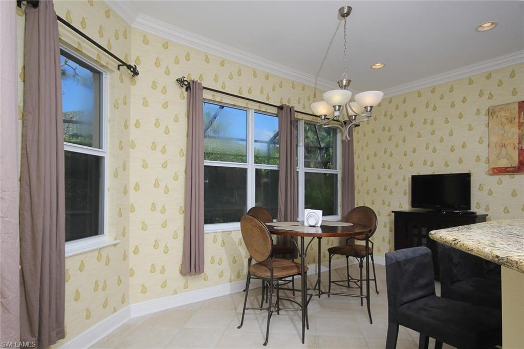 24978 Paradise Road Bonita Springs, FL 34135 - Photo 6 of 25 a dining room with furniture a chandelier and window