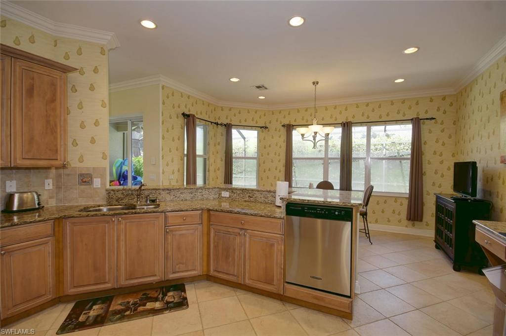 24978 Paradise Road Bonita Springs, FL 34135 - Photo 9 of 25 a kitchen with a sink and cabinets