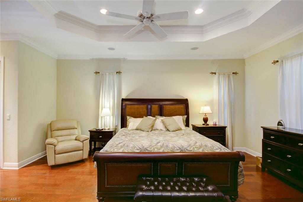 24978 Paradise Road Bonita Springs, FL 34135 - Photo 10 of 25 a bedroom with a bed and furniture