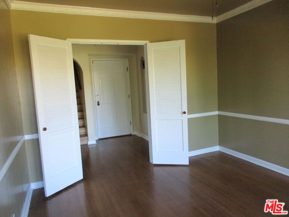 5108 Valley Ridge Avenue View Park, CA 90043 - Photo 11 of 33 an empty room with wooden floor and closet
