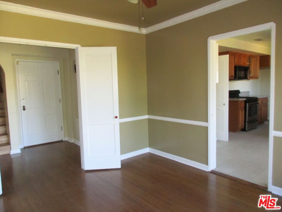 5108 Valley Ridge Avenue View Park, CA 90043 - Photo 12 of 33 an empty room with wooden floor and closet