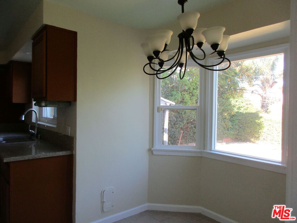 5108 Valley Ridge Avenue View Park, CA 90043 - Photo 14 of 33 a room with a window and chandelier