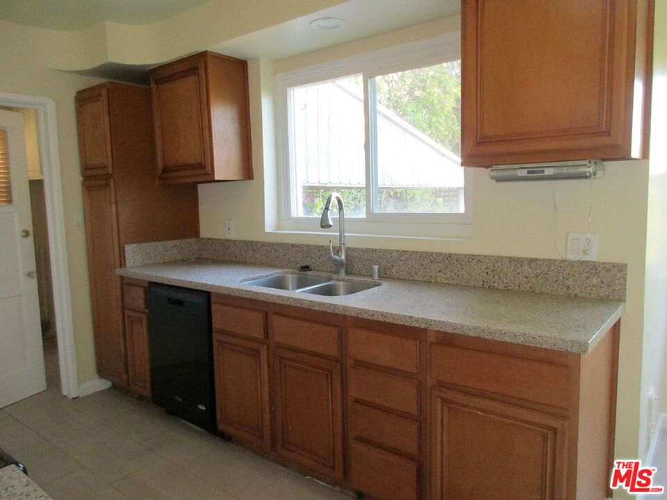 5108 Valley Ridge Avenue View Park, CA 90043 - Photo 16 of 33 a kitchen with a sink cabinets and window