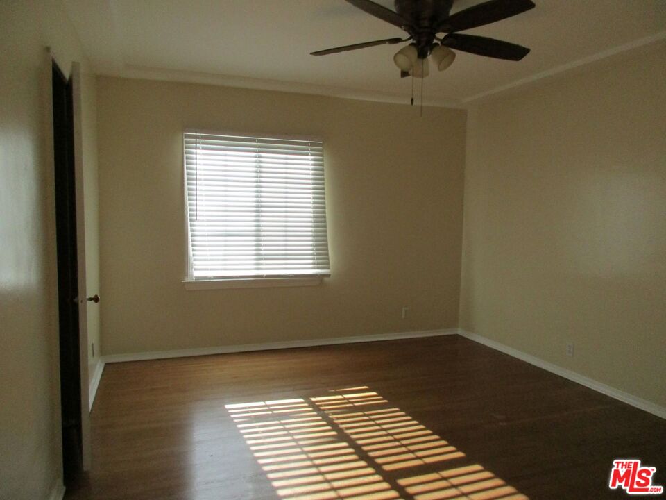 5108 Valley Ridge Avenue View Park, CA 90043 - Photo 19 of 33 a view of a room with a window and wooden floor