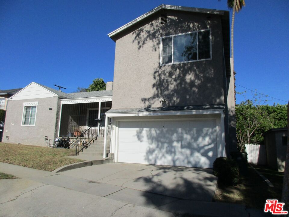 5108 Valley Ridge Avenue View Park, CA 90043 - Photo 2 of 33 a front view of a house with a yard