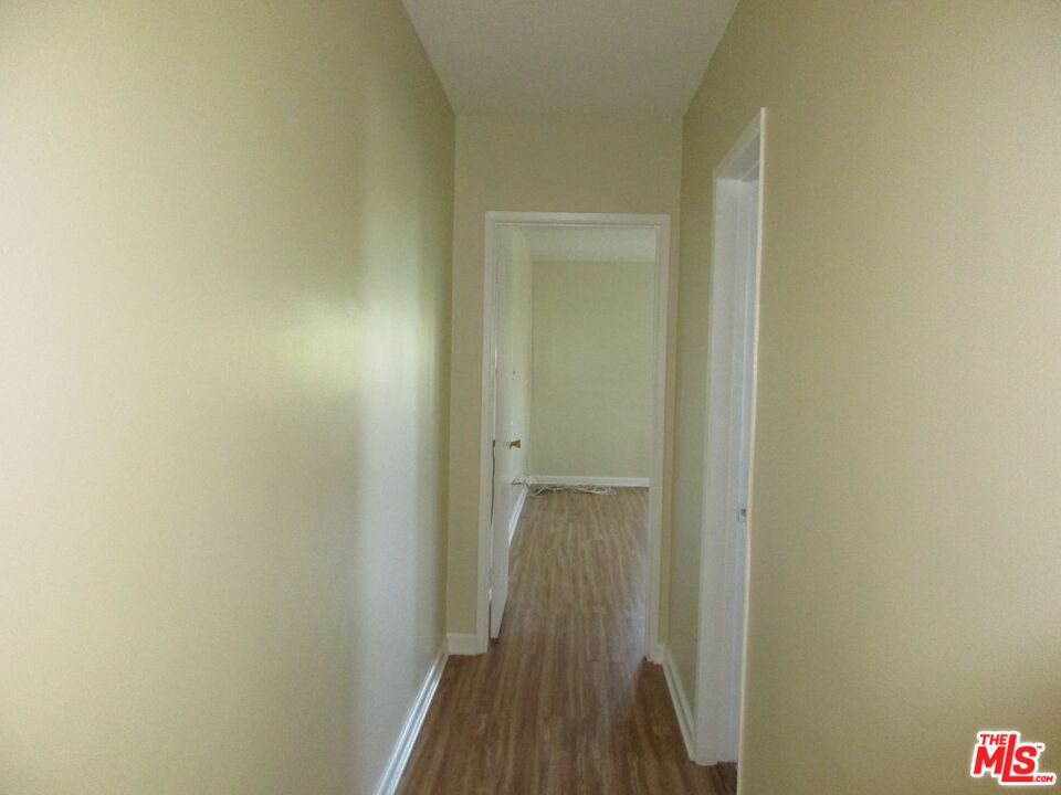 5108 Valley Ridge Avenue View Park, CA 90043 - Photo 28 of 33 a view of a hallway with wooden floor
