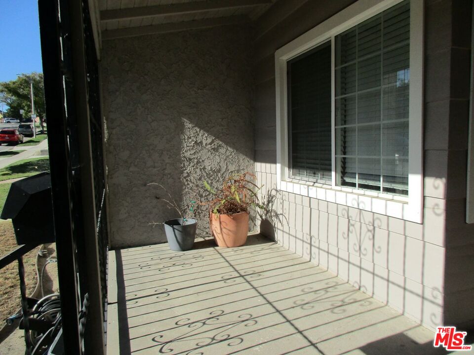 5108 Valley Ridge Avenue View Park, CA 90043 - Photo 5 of 33 a bedroom with a bed and a window