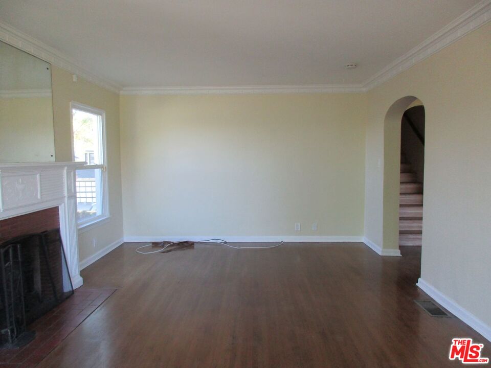 5108 Valley Ridge Avenue View Park, CA 90043 - Photo 8 of 33 wooden floor in an empty room with a window