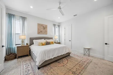 a bedroom with a bed and a lamp