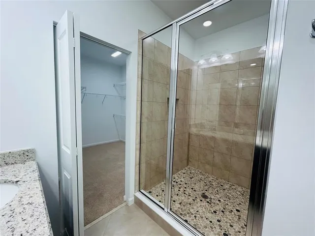 a bathroom with a glass shower door