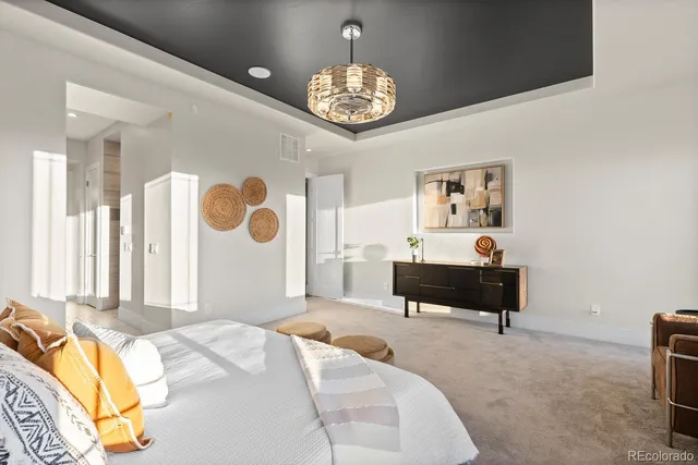 a bedroom with a bed and a chandelier